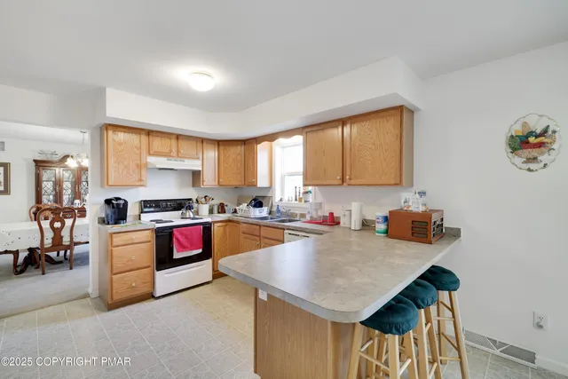 a kitchen with a stove a sink and a refrigerator