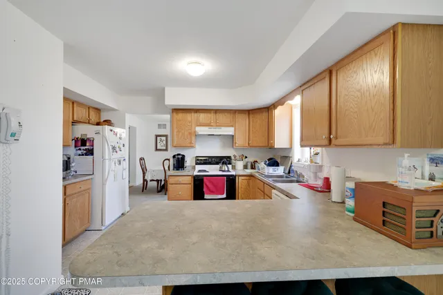 a kitchen with lots of counter top space and refrigerator