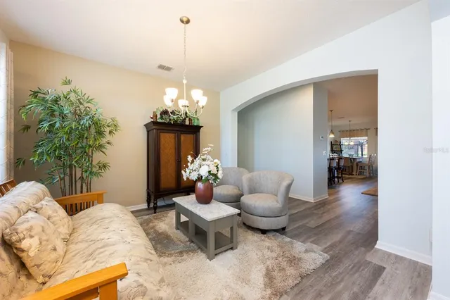 a living room with furniture and a chandelier