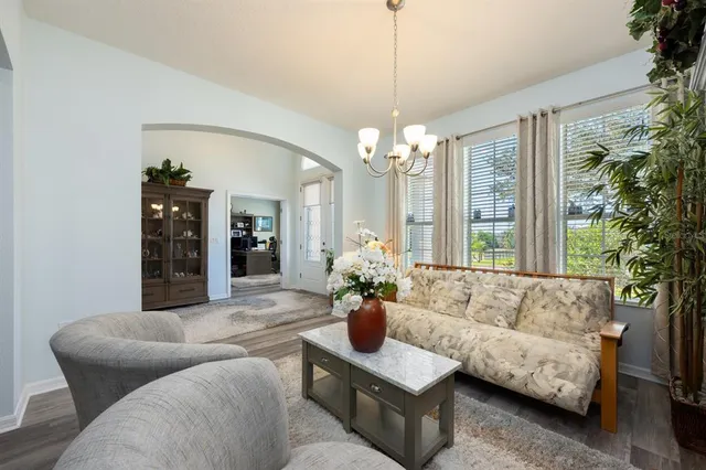 a living room with furniture and a chandelier