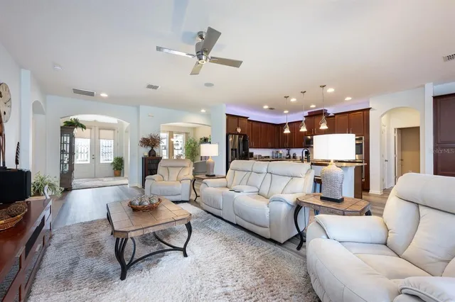 a living room with furniture and kitchen view