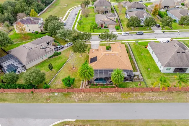 an aerial view of a house with a swimming pool