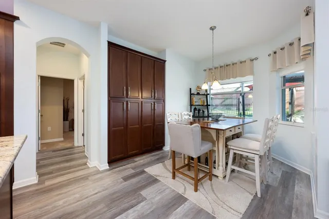 a view of a dining room with furniture window and wooden floor