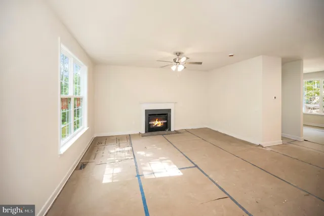 a view of a livingroom with a ceiling fan and window