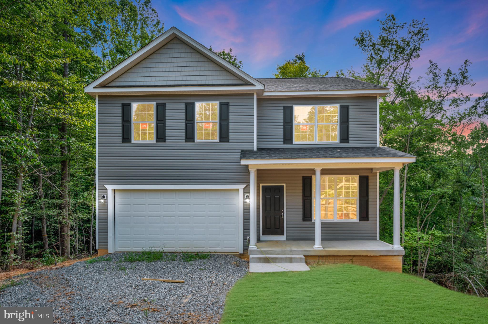 6077 Hamlin Circle King George, VA 22485 - Photo 2 of 50 a front view of a house with garden