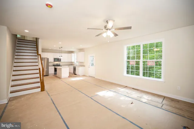 a view of a kitchen with utility room and stairs