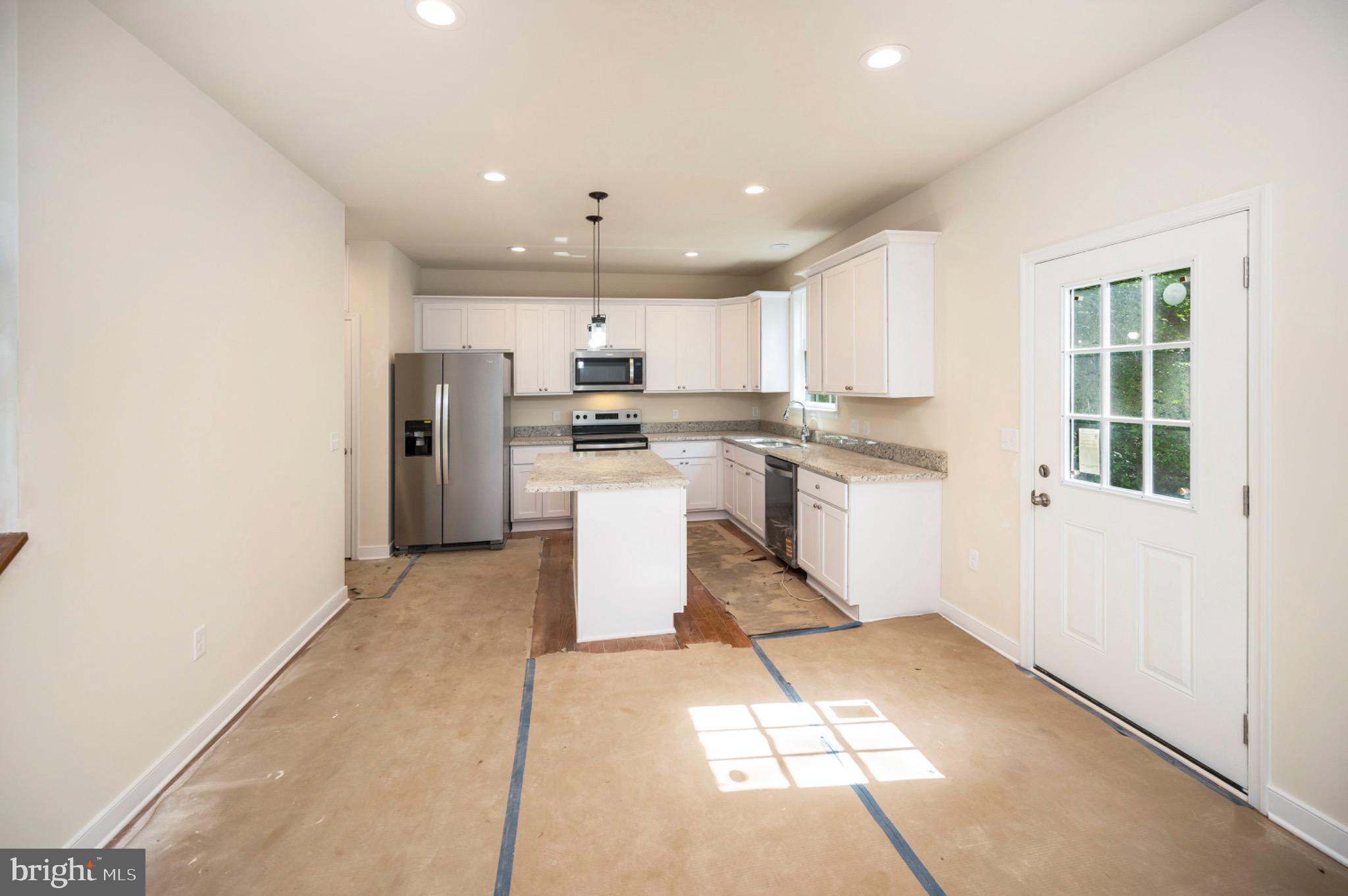 6077 Hamlin Circle King George, VA 22485 - Photo 24 of 50 a kitchen with stainless steel appliances granite countertop a refrigerator and a stove top oven