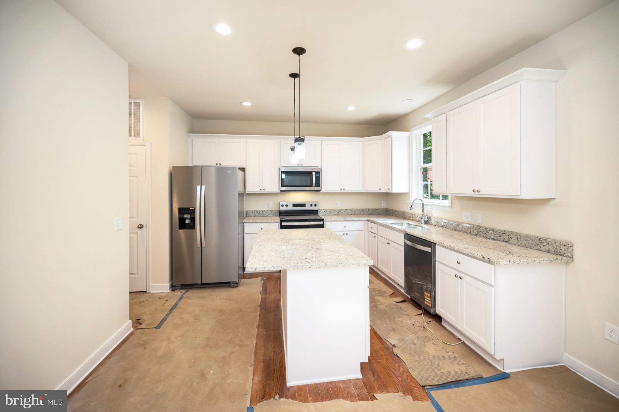 6077 Hamlin Circle King George, VA 22485 - Photo 25 of 50 a kitchen with stainless steel appliances granite countertop a refrigerator a stove a sink and white cabinets with wooden floor