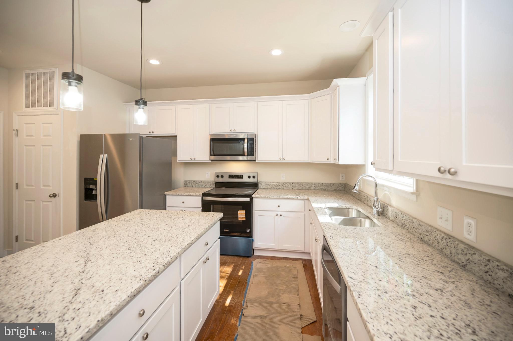 6077 Hamlin Circle King George, VA 22485 - Photo 27 of 50 a kitchen with a sink a counter top space stainless steel appliances and cabinets