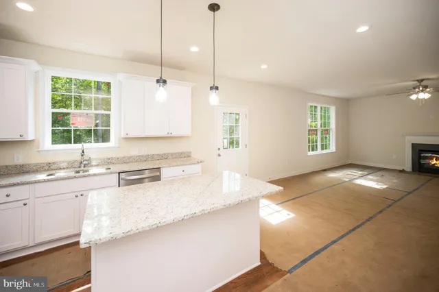 a kitchen with granite countertop a sink and a window