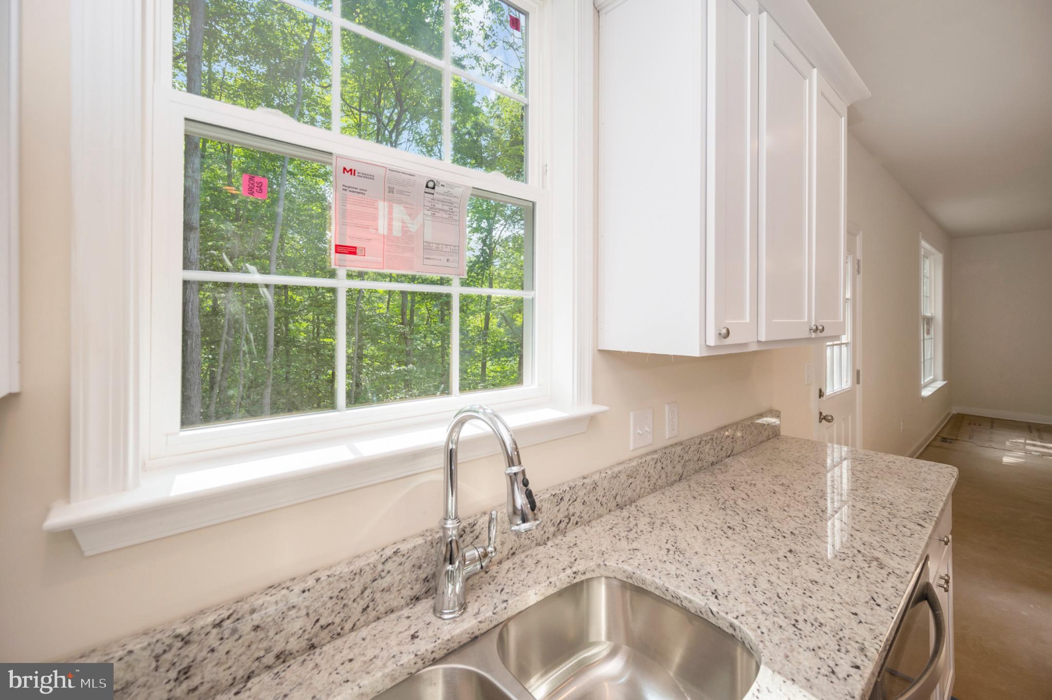 6077 Hamlin Circle King George, VA 22485 - Photo 32 of 50 a kitchen with granite countertop a sink and a window
