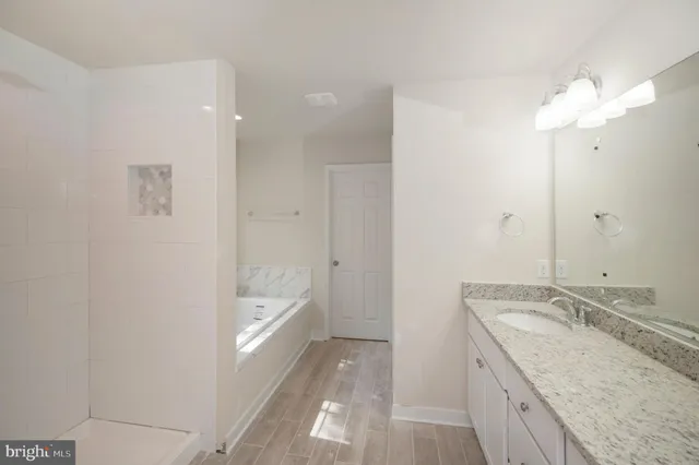 a bathroom with a bathtub and shower