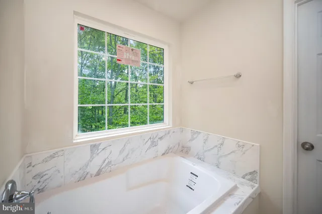 a bathroom with a granite countertop sink a mirror and a shower