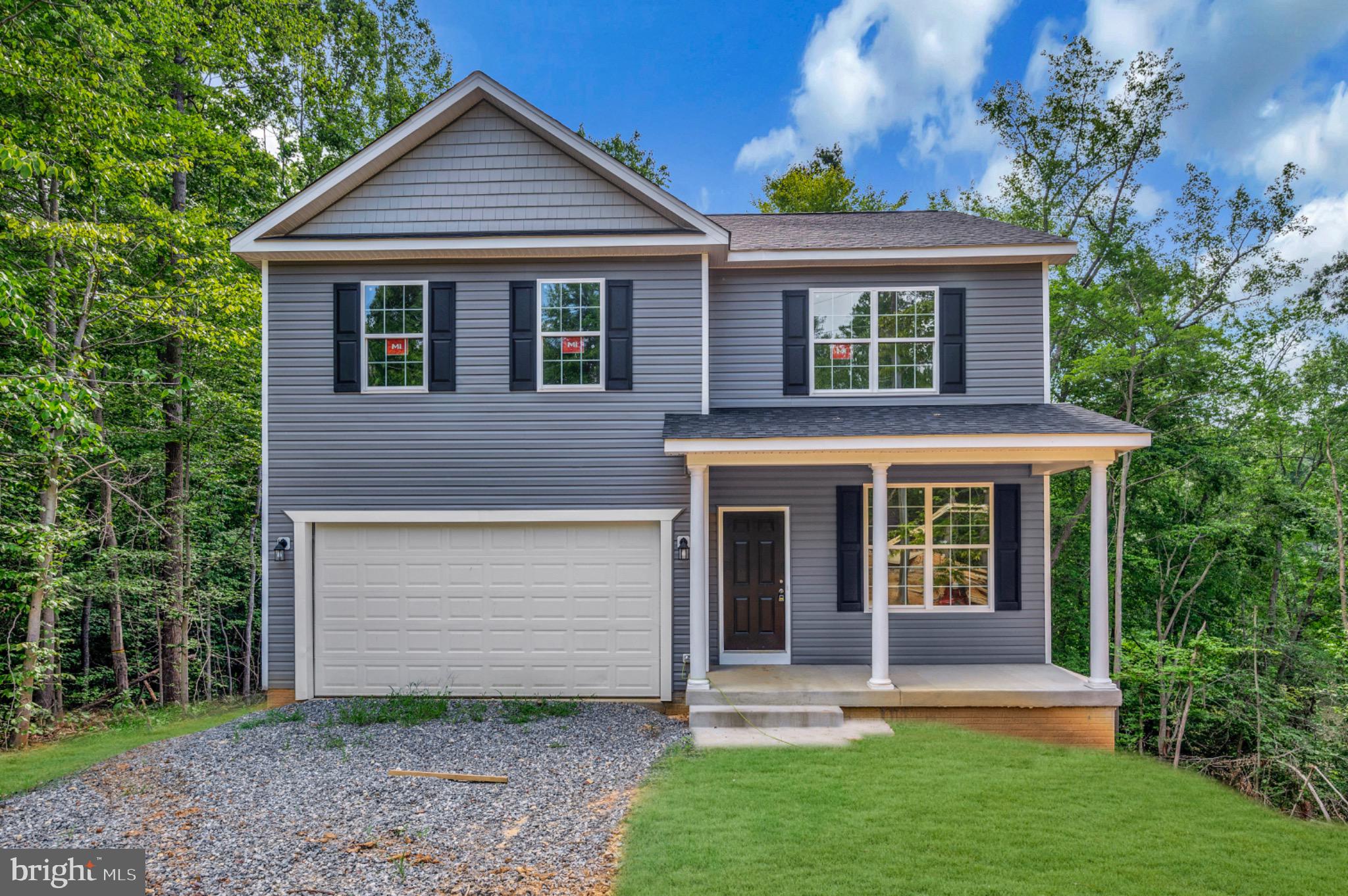 6077 Hamlin Circle King George, VA 22485 - Photo 4 of 50 a front view of a house with a yard and an outdoor seating