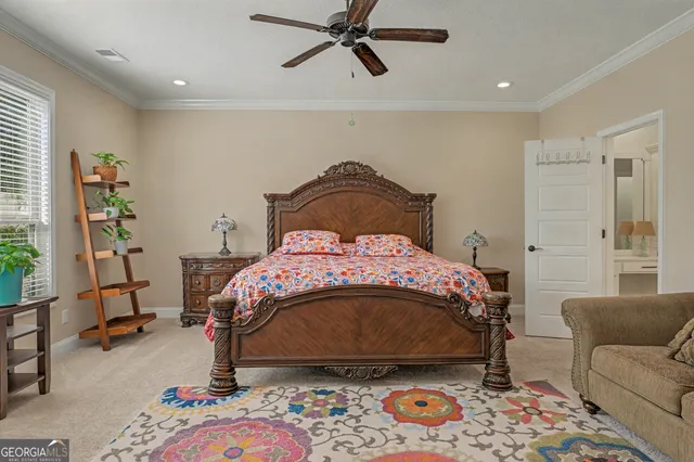 a bedroom with a bed furniture and a potted plant