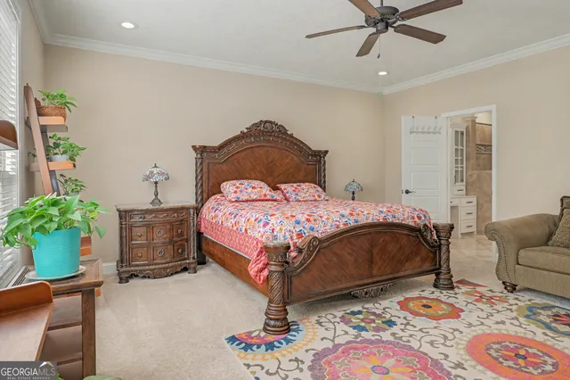 a bedroom with two beds and potted plant