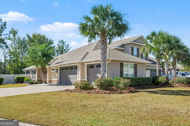 a front view of a house with a garden