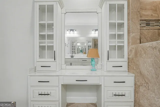 a view of walk in closet with clothes