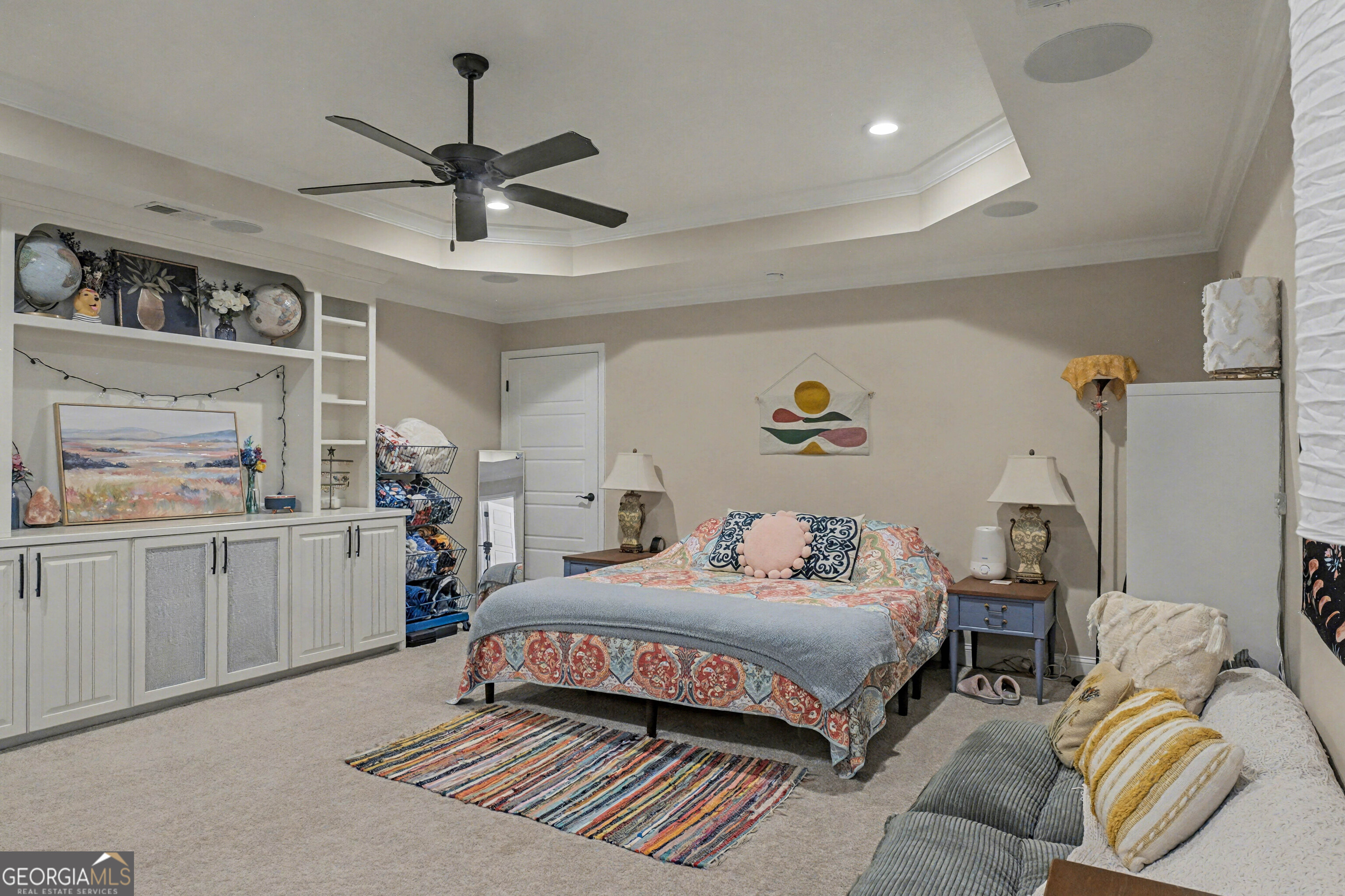 102 Thomas Court Kingsland, GA 31548 - Photo 40 of 59 a bedroom with a bed couch and lots of painting on the wall