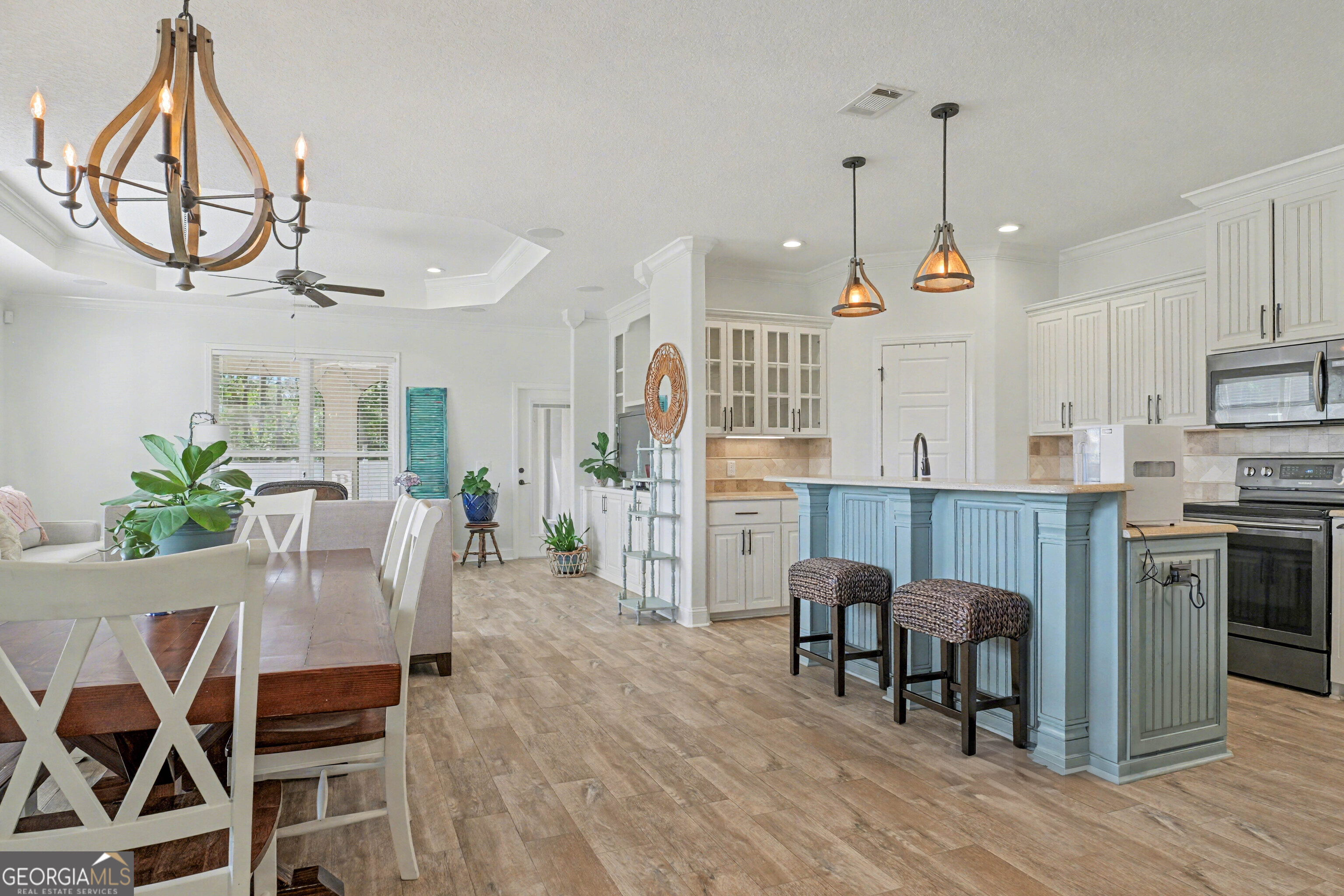 102 Thomas Court Kingsland, GA 31548 - Photo 6 of 59 a dining room with furniture a chandelier and wooden floor