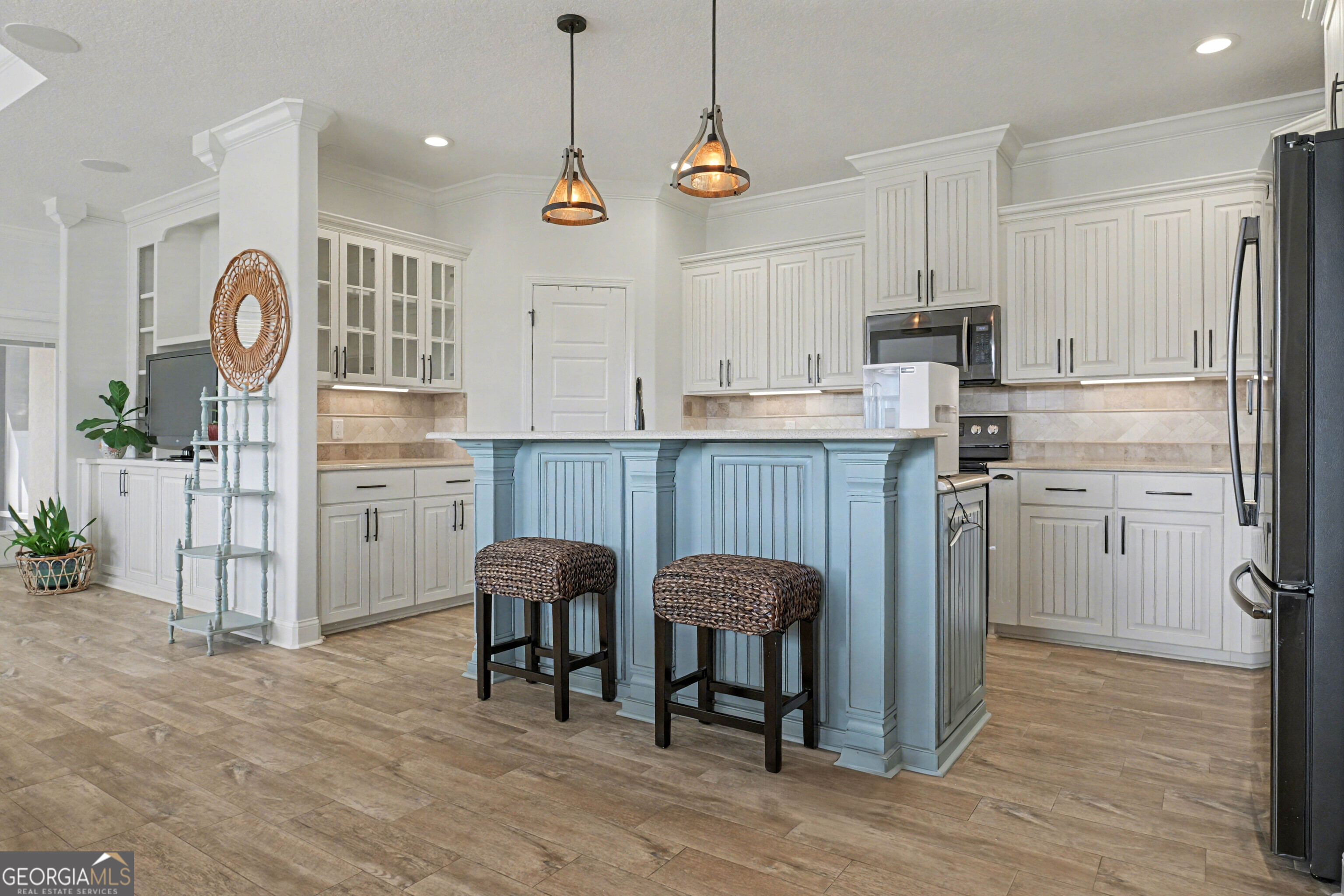 102 Thomas Court Kingsland, GA 31548 - Photo 7 of 59 a kitchen with granite countertop a table chairs refrigerator and cabinets