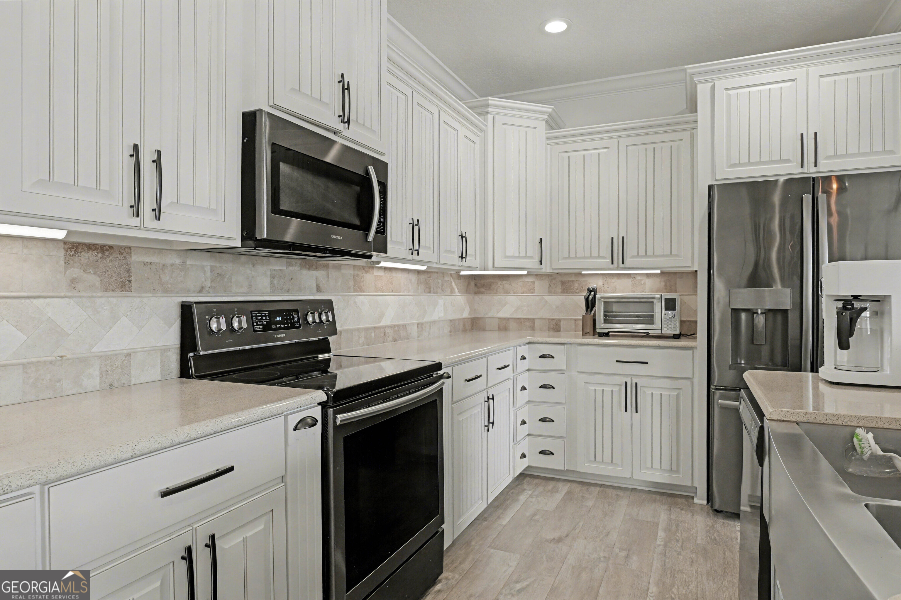 102 Thomas Court Kingsland, GA 31548 - Photo 9 of 59 a kitchen with cabinets stainless steel appliances and a counter space
