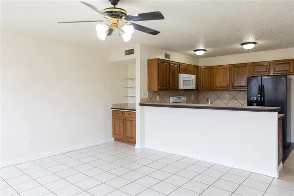 a kitchen with kitchen island granite countertop cabinets and stainless steel appliances