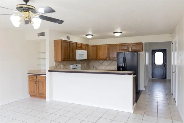 a view of a kitchen with granite countertop cabinets and stainless steel appliances