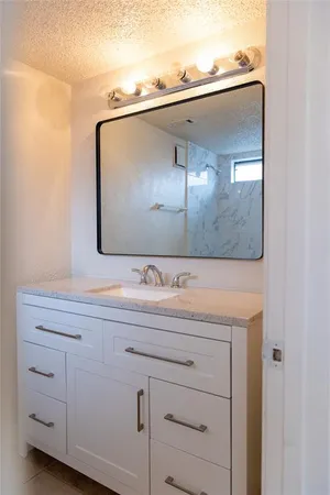 a bathroom with a sink and mirror