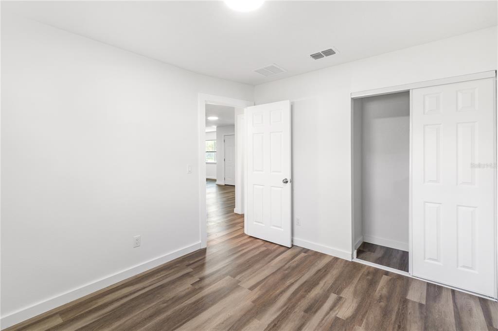 426 Bascom Court Polk City, FL 33868 - Photo 21 of 33 a view of an empty room and wooden floor