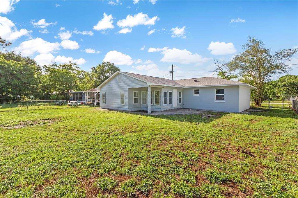 426 Bascom Court Polk City, FL 33868 - Photo 26 of 33 a view of a house with a backyard
