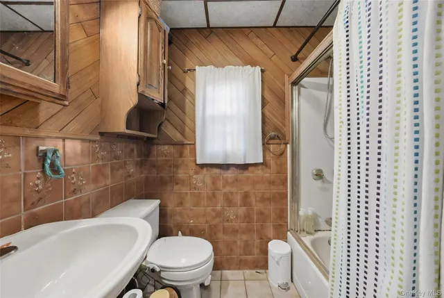 a white toilet sitting next to a bathroom sink
