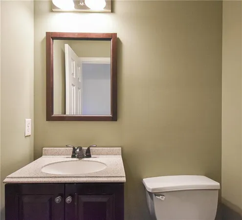 an empty room with windows and ceiling fan