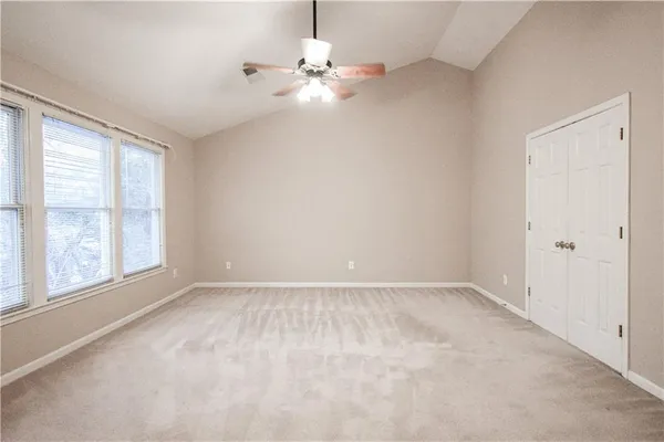 a spacious bathroom with a tub sink and mirror