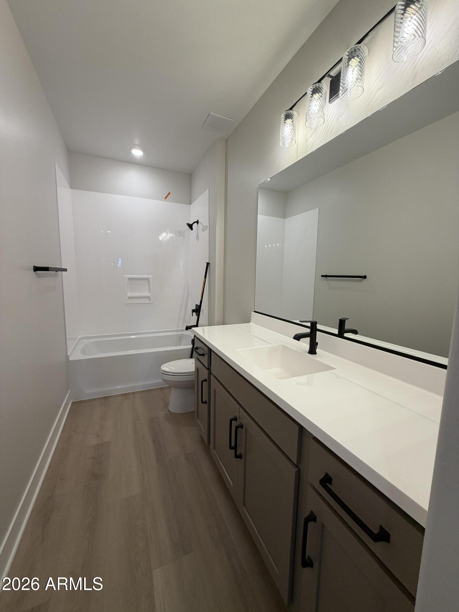 15767 West Sand Hills Road Surprise, AZ 85387 - Photo 28 of 60 a bathroom with a sink a toilet and a mirror