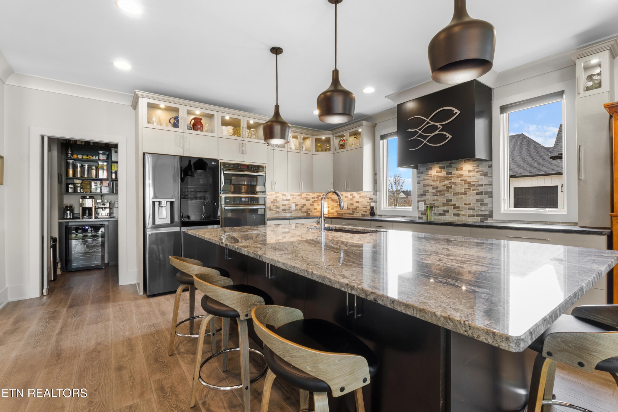 3702 Promontory Point Louisville, TN 37777 - Photo 8 of 60 a kitchen with stainless steel appliances granite countertop a sink a stove and a wooden floor