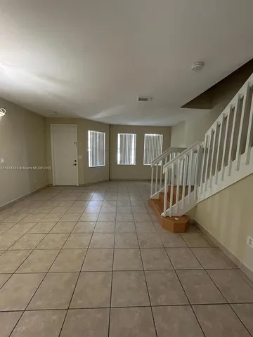 a view of an empty room with windows