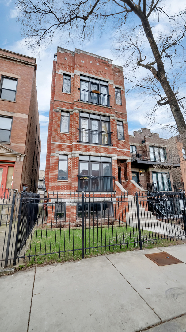 2417 West Fillmore Street, Unit 1 Chicago, IL 60612 - Photo 1 of 19 a view of a brick building next to a yard