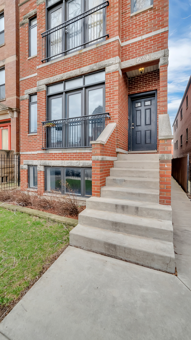 2417 West Fillmore Street, Unit 1 Chicago, IL 60612 - Photo 2 of 19 a front view of a house with a yard