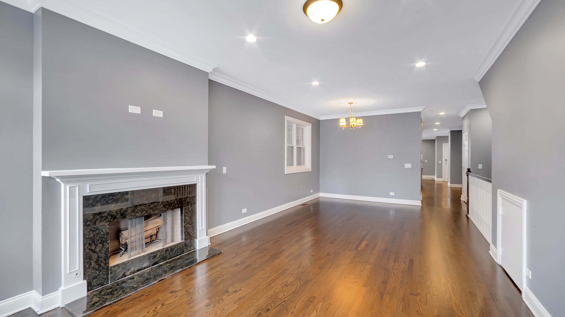 2417 West Fillmore Street, Unit 1 Chicago, IL 60612 - Photo 3 of 19 an empty room with wooden floor fireplace and windows