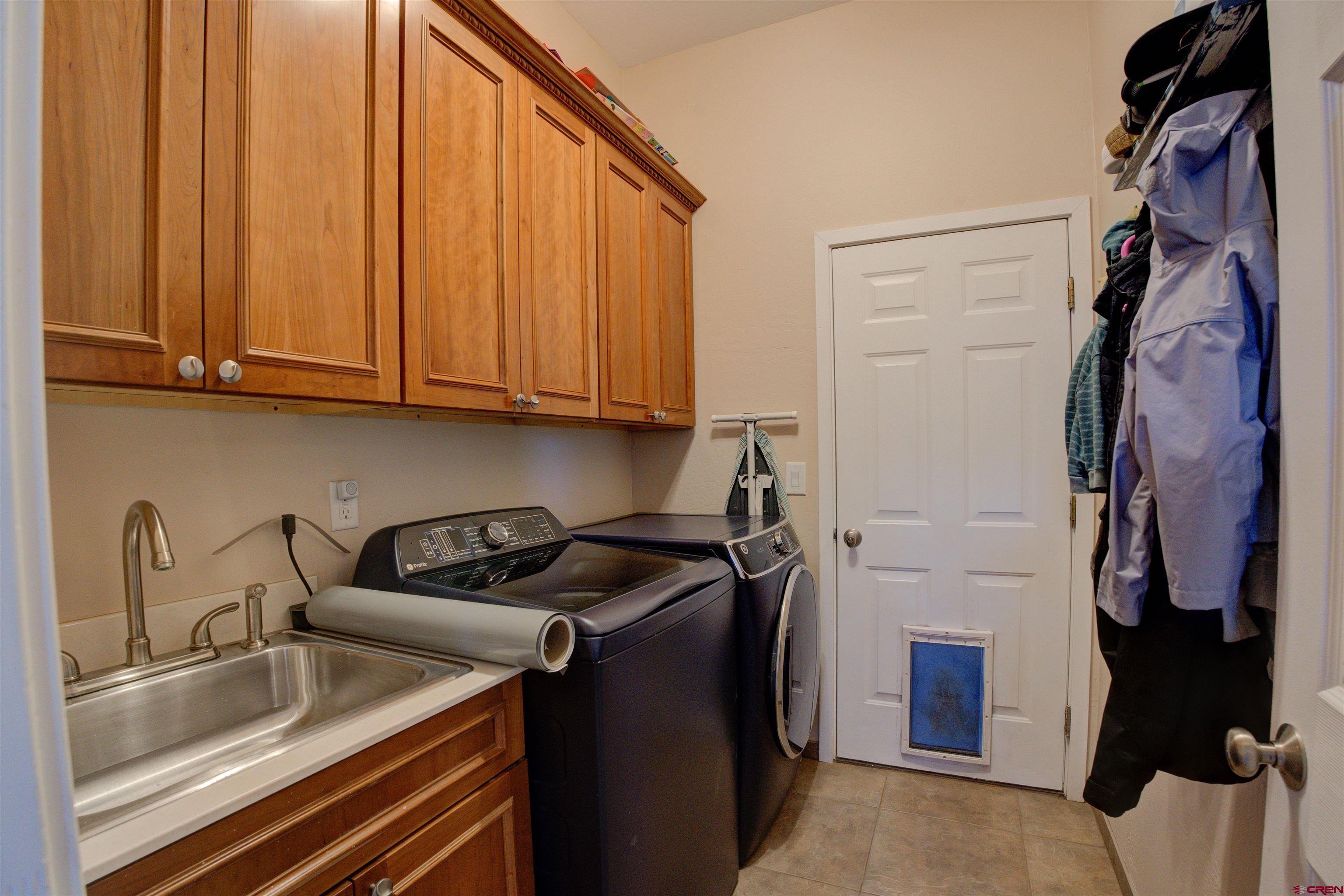 12868 Road 24.4 Loop Cortez, CO 81321 - Photo 11 of 28 a kitchen with a sink and cabinets