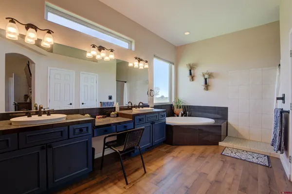 a large bathroom with a double vanity sink and a mirror