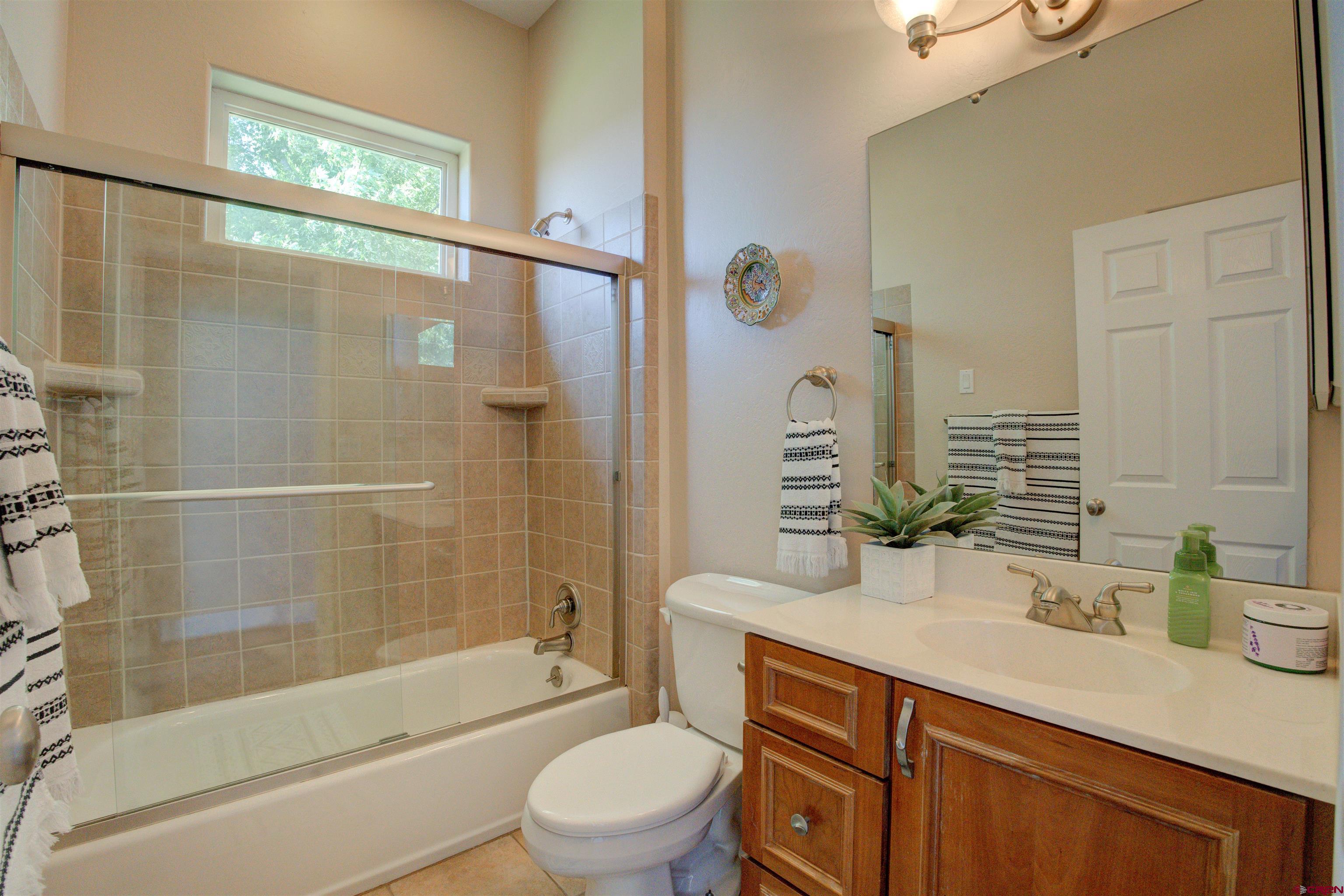12868 Road 24.4 Loop Cortez, CO 81321 - Photo 17 of 28 a bathroom with a sink a toilet and shower