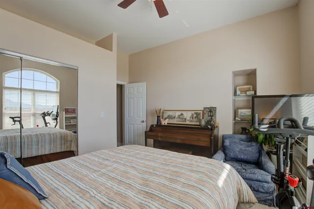 a bedroom with a bed and wooden floor