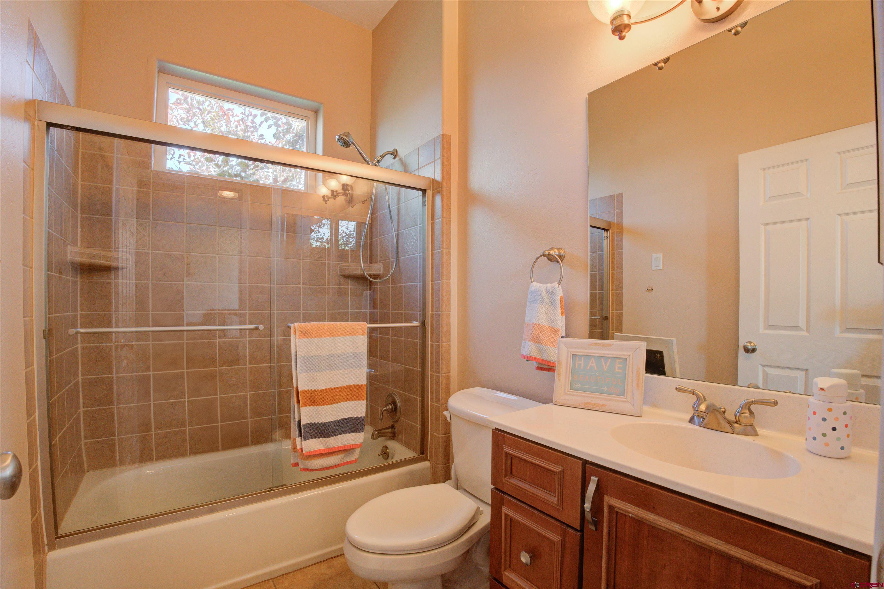 12868 Road 24.4 Loop Cortez, CO 81321 - Photo 19 of 28 a bathroom with a sink a toilet and shower