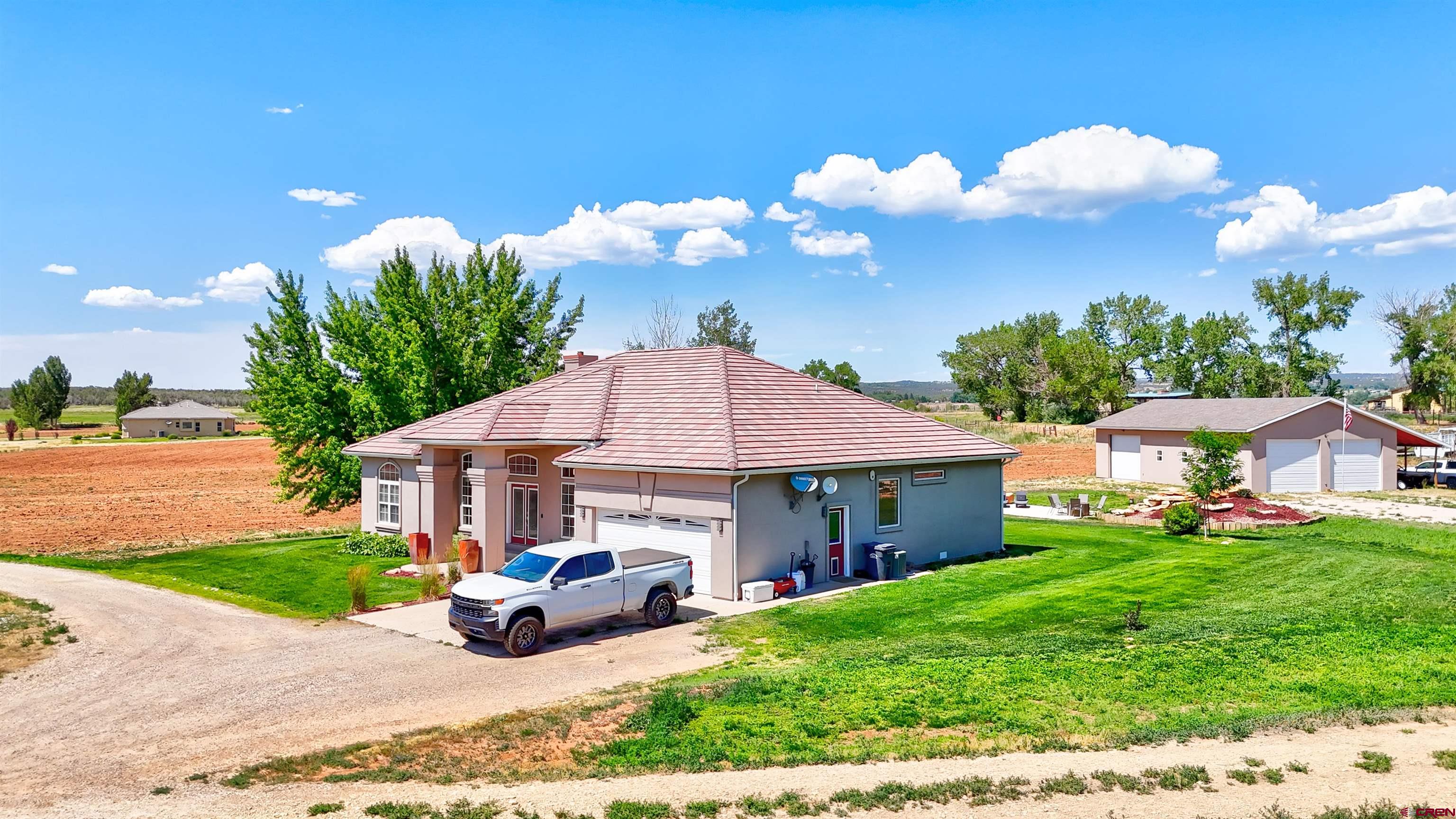 12868 Road 24.4 Loop Cortez, CO 81321 - Photo 2 of 28 a view of a house with backyard porch and sitting area
