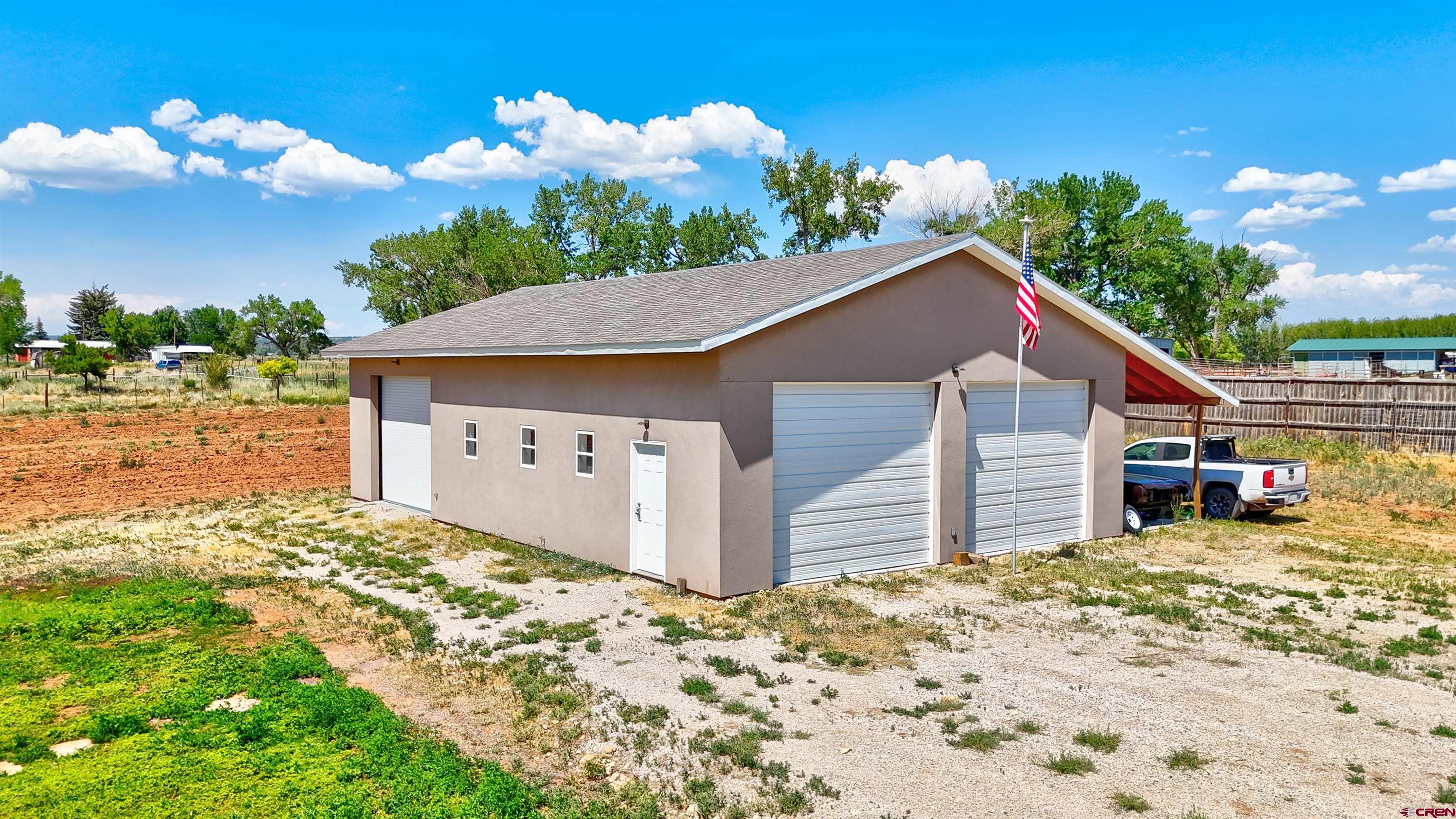 12868 Road 24.4 Loop Cortez, CO 81321 - Photo 21 of 28 a view of a house with a yard