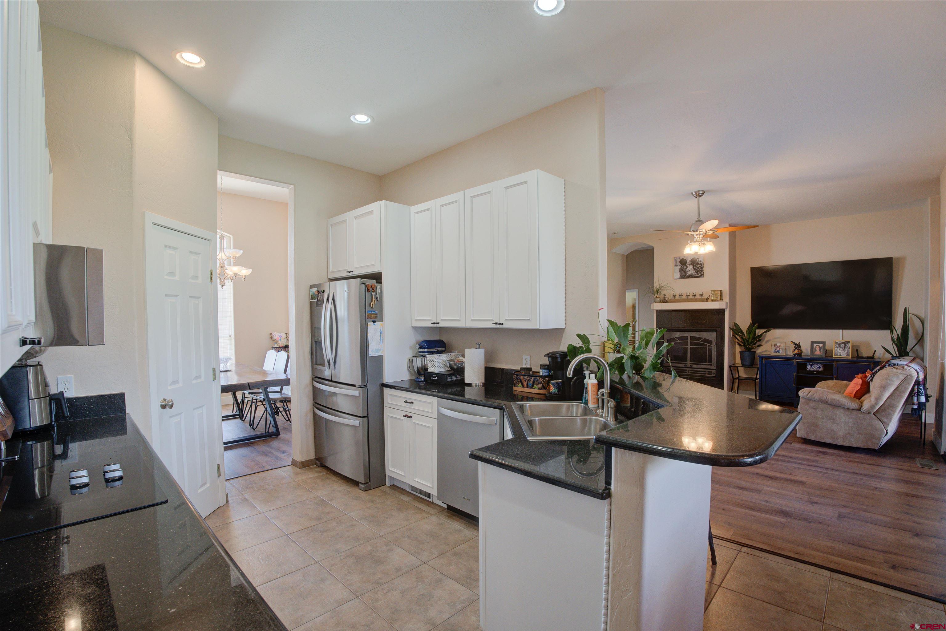 12868 Road 24.4 Loop Cortez, CO 81321 - Photo 9 of 28 a kitchen with a sink stove and refrigerator