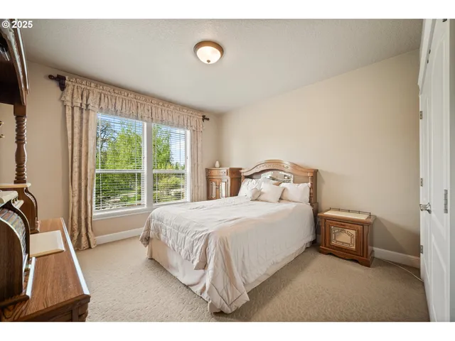 a bedroom with a bed and a large window