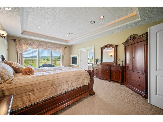 a bedroom with a large bed and wooden floor